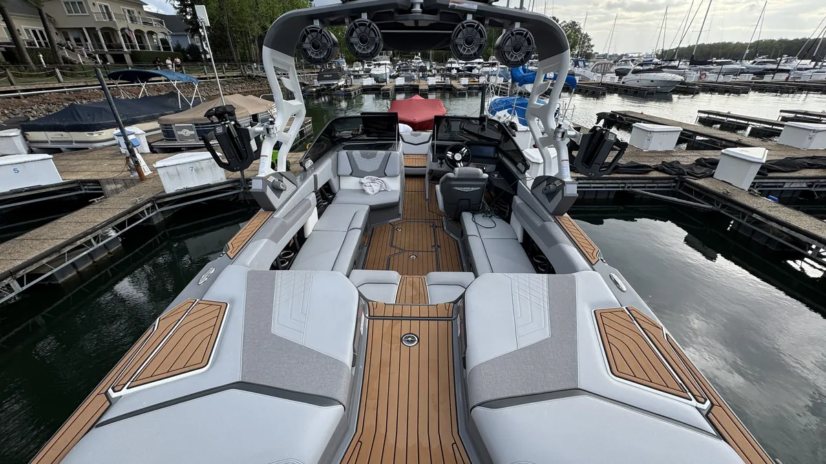 Spotless surf boat interior with clean seating and teak-style flooring at a Lake Norman marina