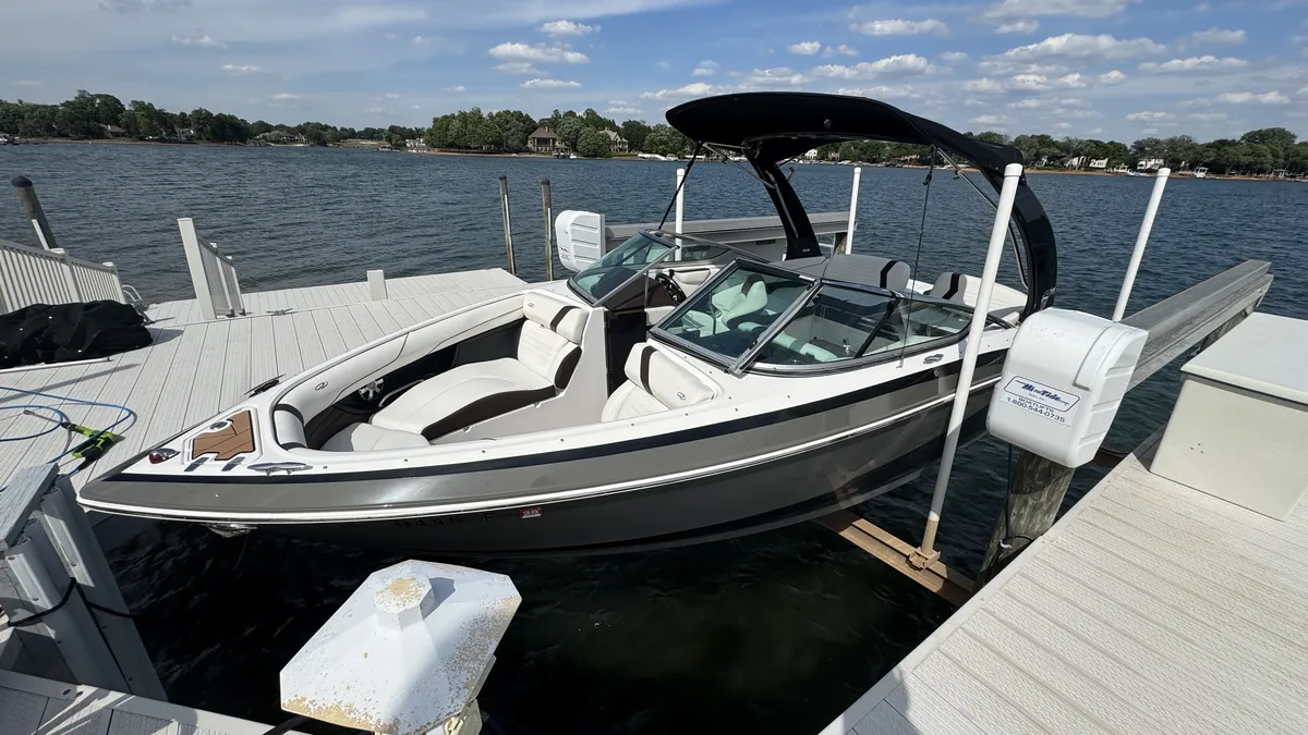 Spotless wake boat on its lift on Lake Norman after a Dirty Work detail